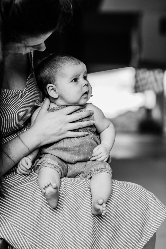 black and white photo of baby girl looking towards her dad