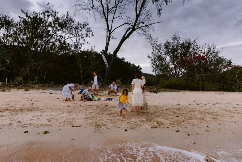 All the family enjoy a picnic at the beach late in the afternoon at Geoffrey Bay Magnetic Island.