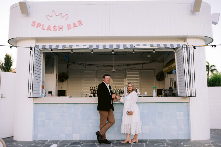 Hannah and Terry celebrate their marriage with a glass of sparkling at the Splash Bar at the Ville in Townsville.