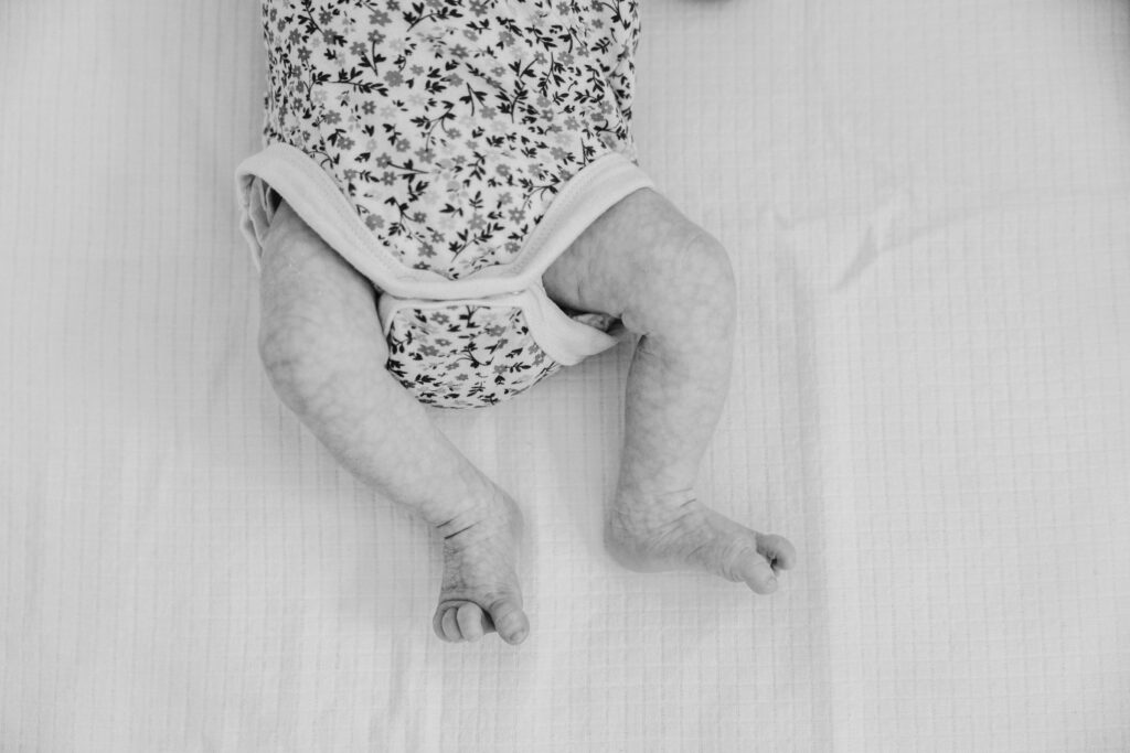 The little legs and toes of the other twin baby girl.