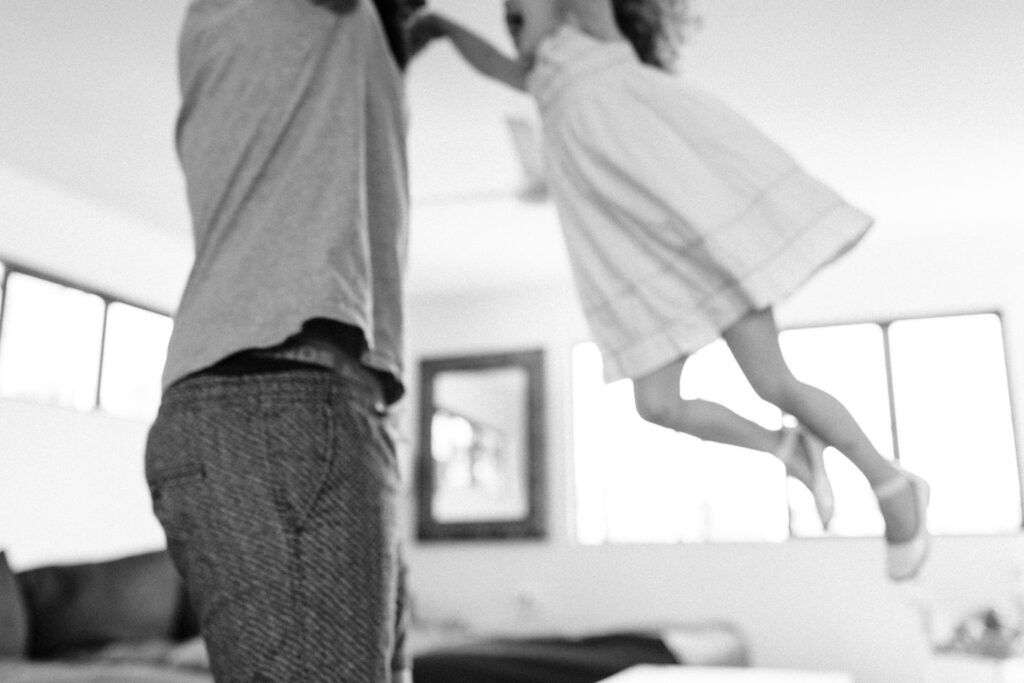 Pip and her Daddy dance in the lounge room