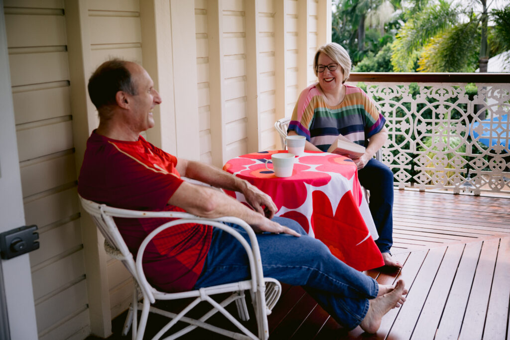 Cathy and Peter naturally sit on the patio relaxing with a cup of tea.