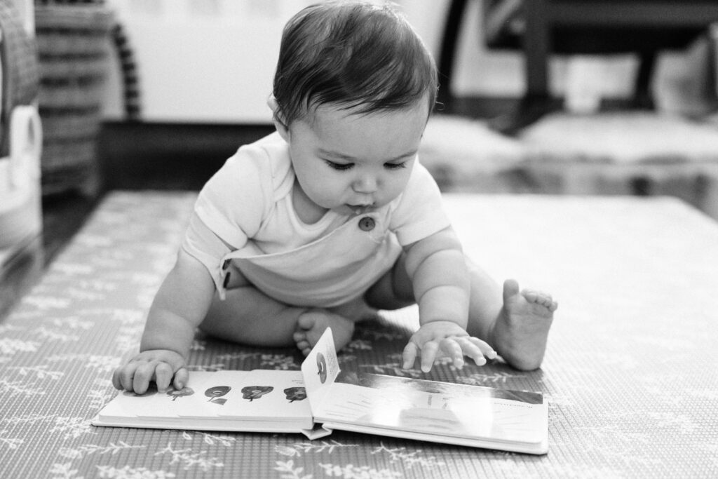 Baby boy looking at a book