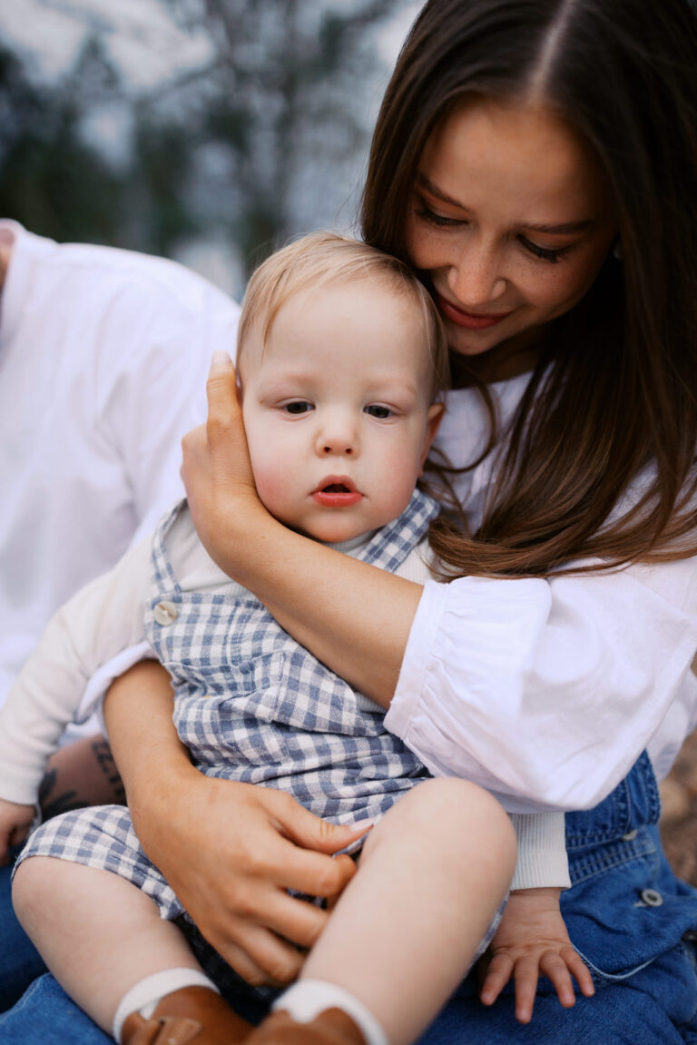 a mumma holds her son tightly and lovingly against her