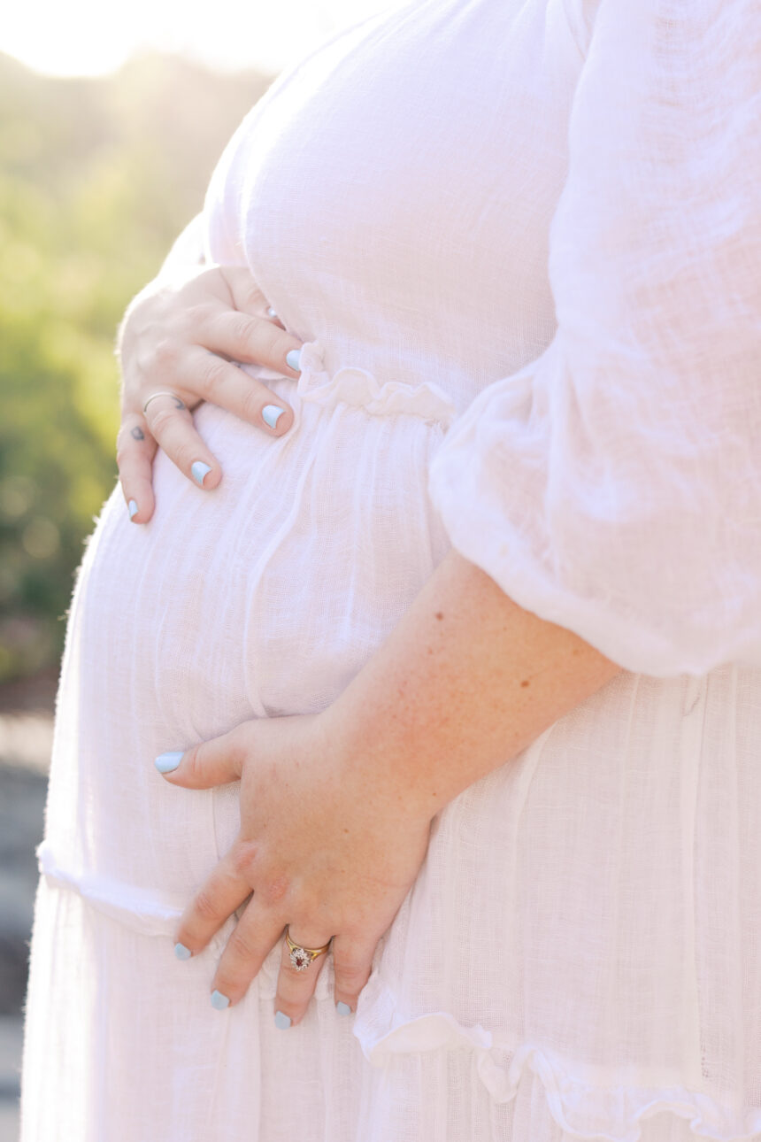 A pregnant women holding her baby bump