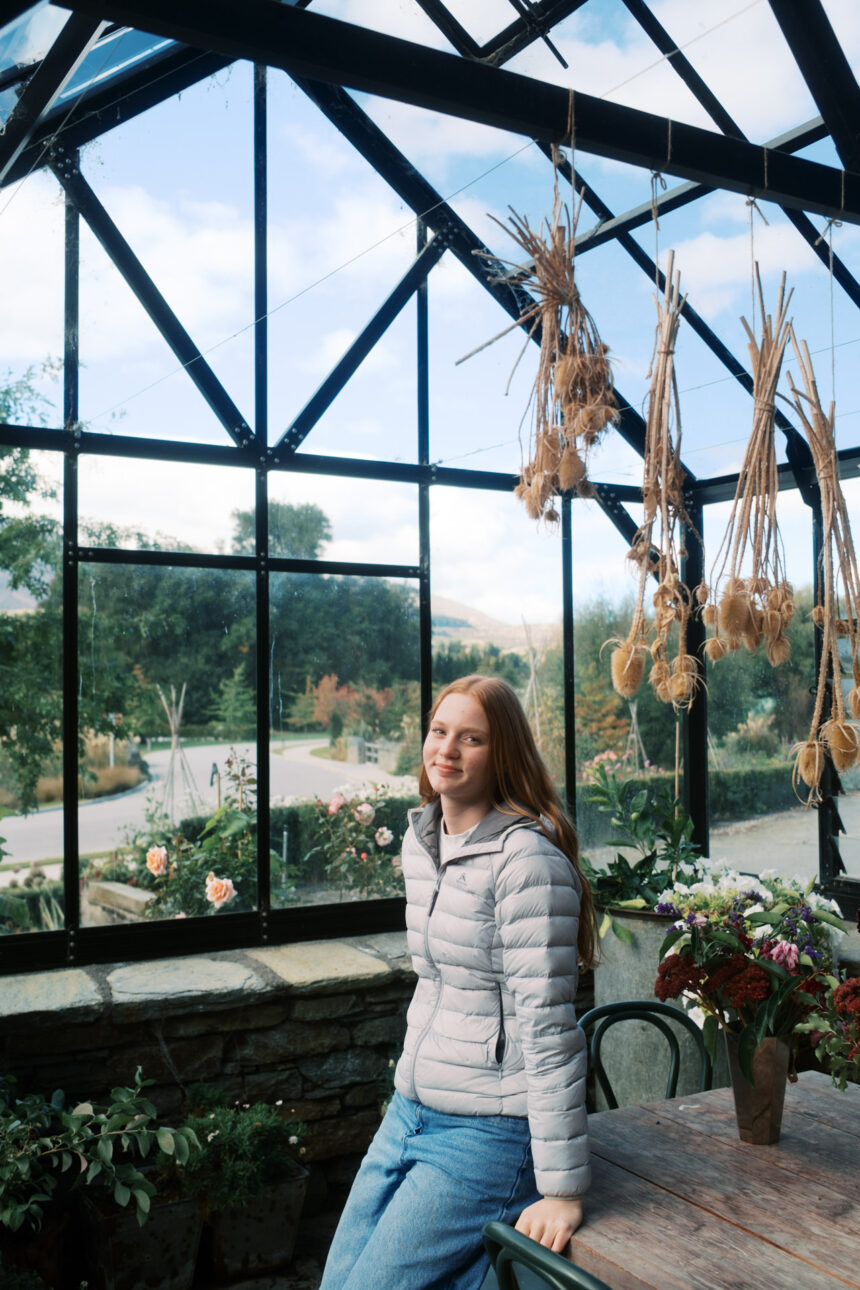 A young girl is resting on the table in the green house at Ayrburn Winery Queenstown