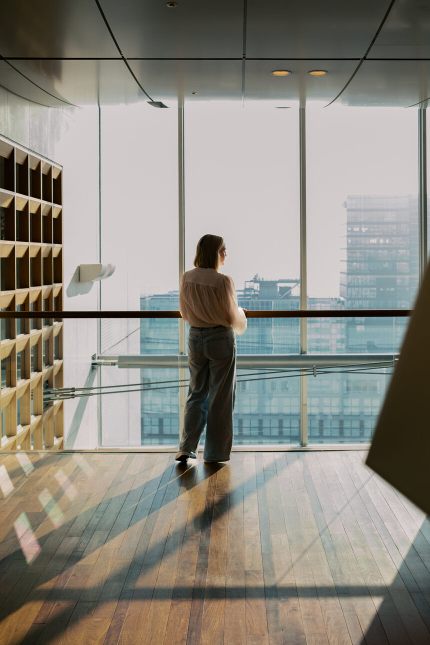 A lady is looking out over Tokyo from the foyer of Hotel Excel in Shinjuku