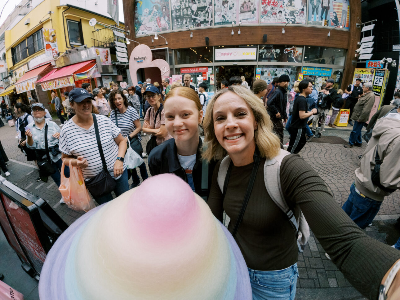 A mother and daughter are on a girls trip to Tokyo and are eating fairy floss bigger than their heads in Harijuku