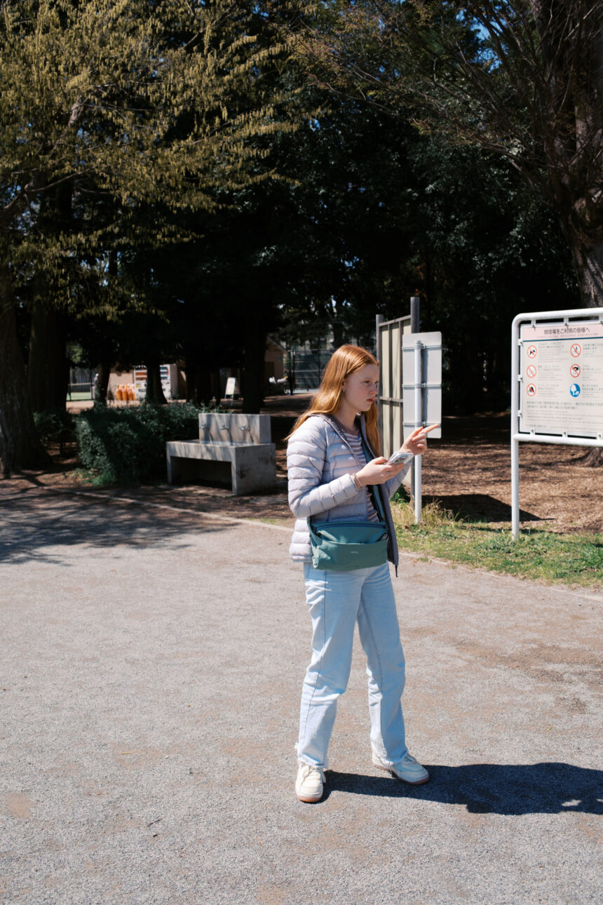 A young teenage girl is navigating around Tokyo