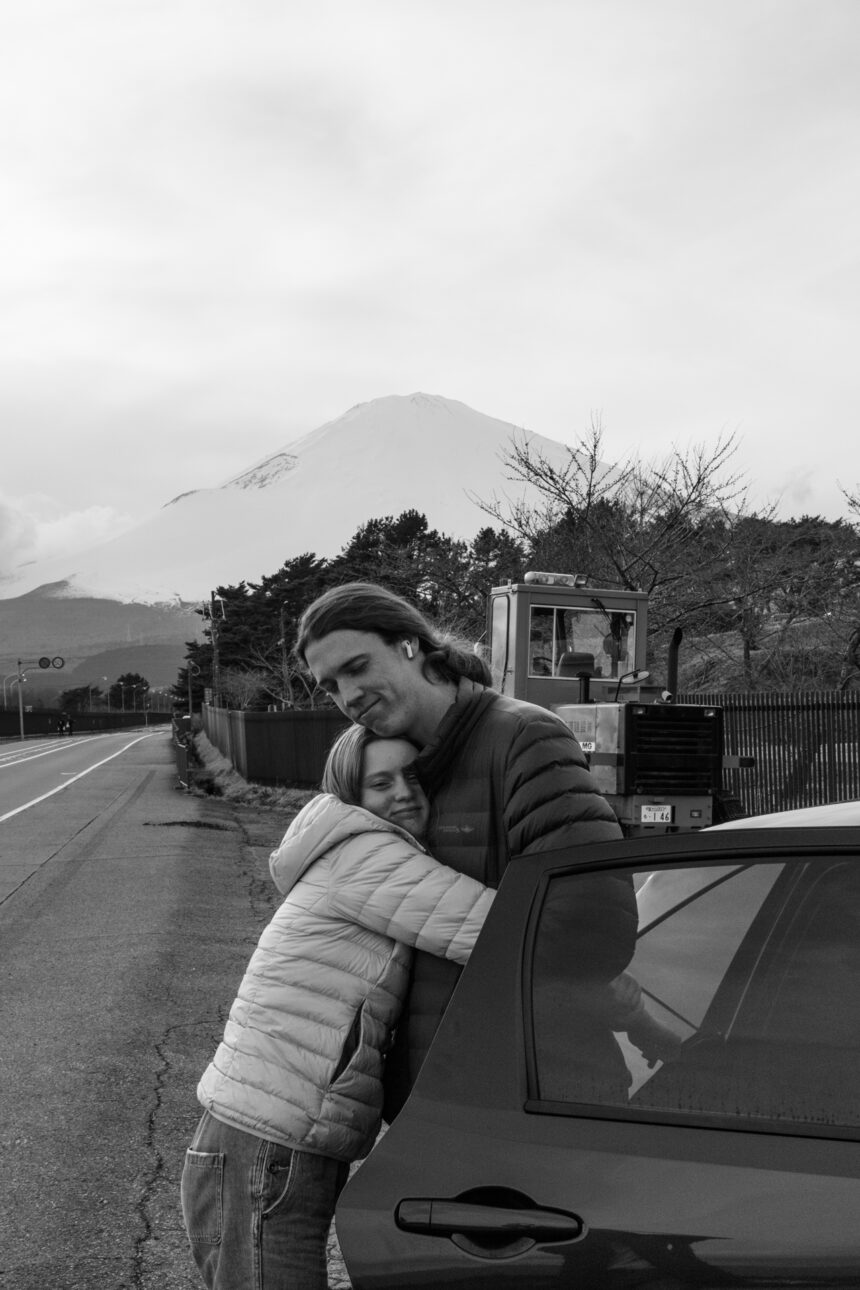 A younger sister hugs her older brother