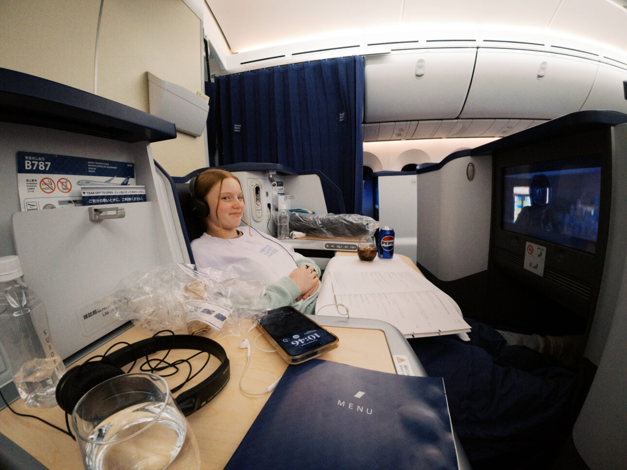 A teenage girl is relaxed in Air Nippon Business Class