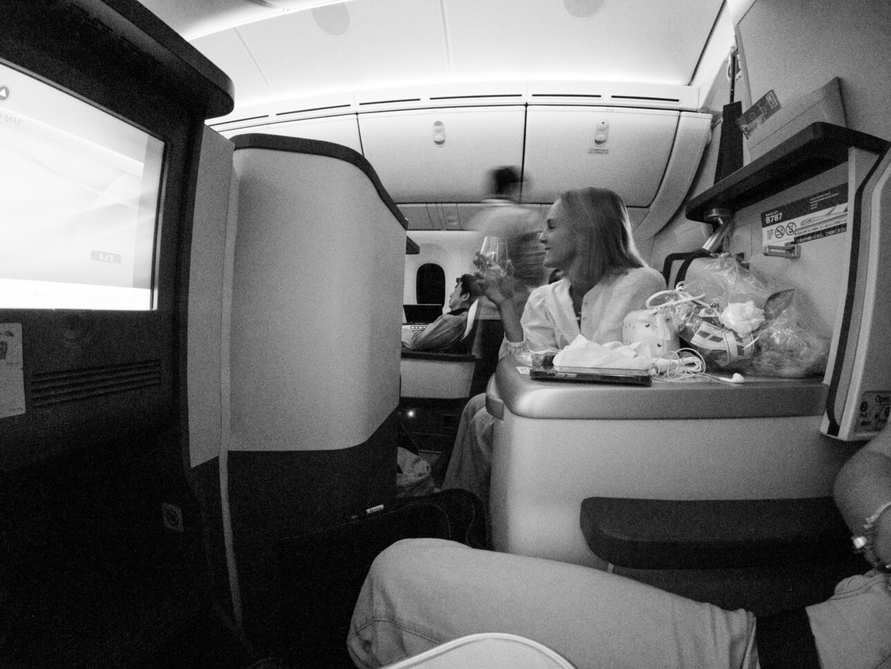 a lady is sitting enjoying ANA Air Nippon Business Class