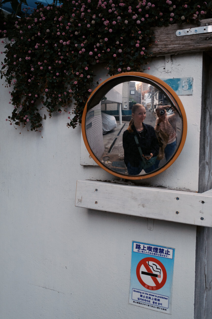 Reflection of a mother and daughter in a back street in Tokyo